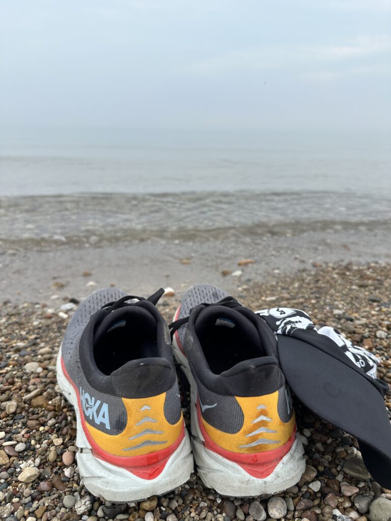 Running shoes on the shore of Lake Michigan after an early morning run.